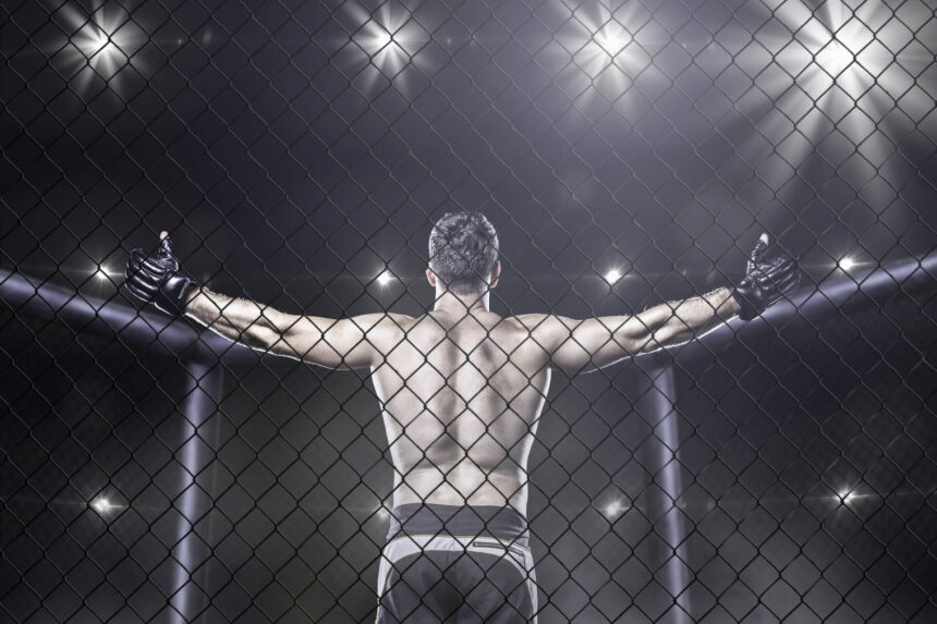 An MMA fighter raising his arms showing who has the most wins in UFC history