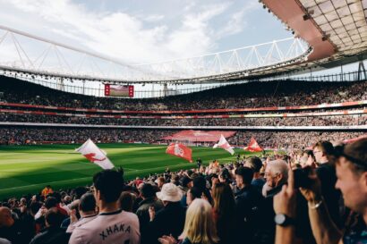 Fans at the emirates stadium showing how much does it cost to be a football fan