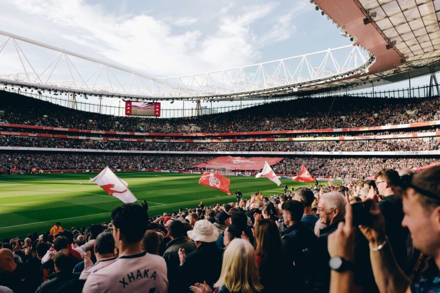 Fans at the emirates stadium showing how much does it cost to be a football fan