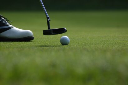 A putter and golf ball showing when is the pga championship